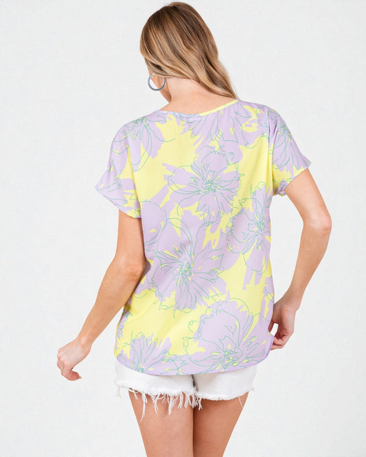 Woman wearing a floral patterned t-shirt on a white background