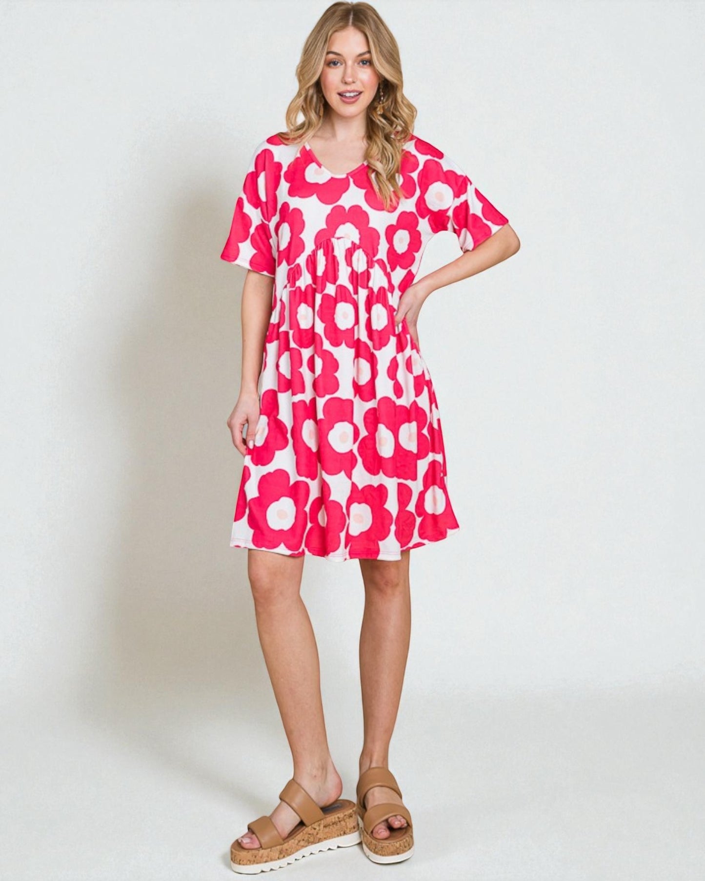 Woman wearing a pink floral dress on a white background