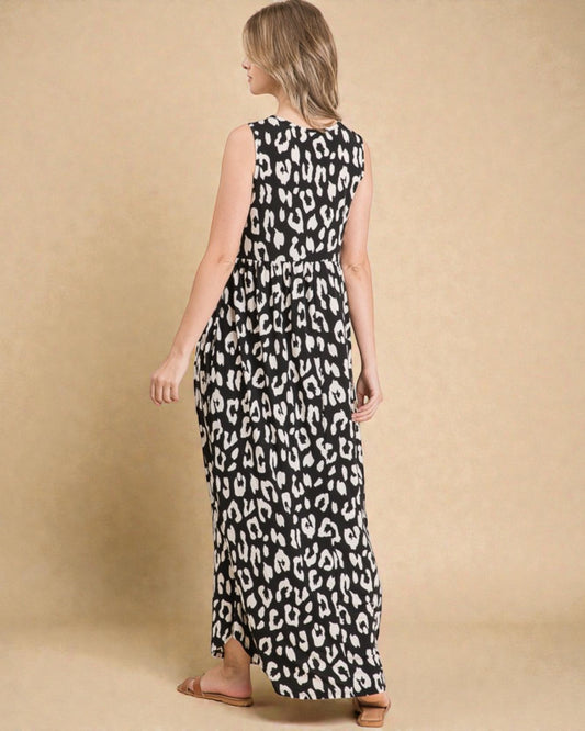 Woman wearing a black and white leopard print dress against a beige background