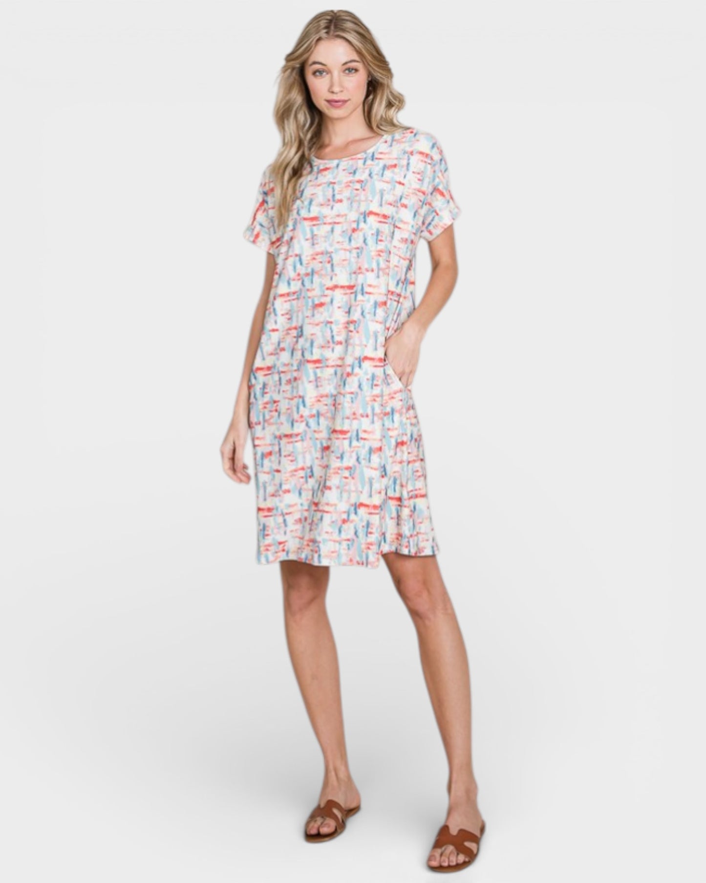 Woman wearing a patterned dress on a white background