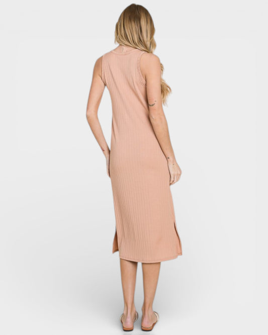 Woman wearing a beige sleeveless dress on a white background