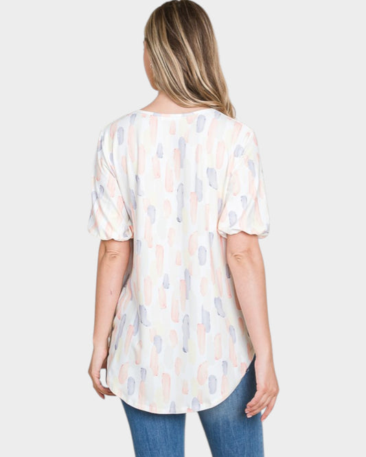 Woman wearing a patterned blouse with a plain background