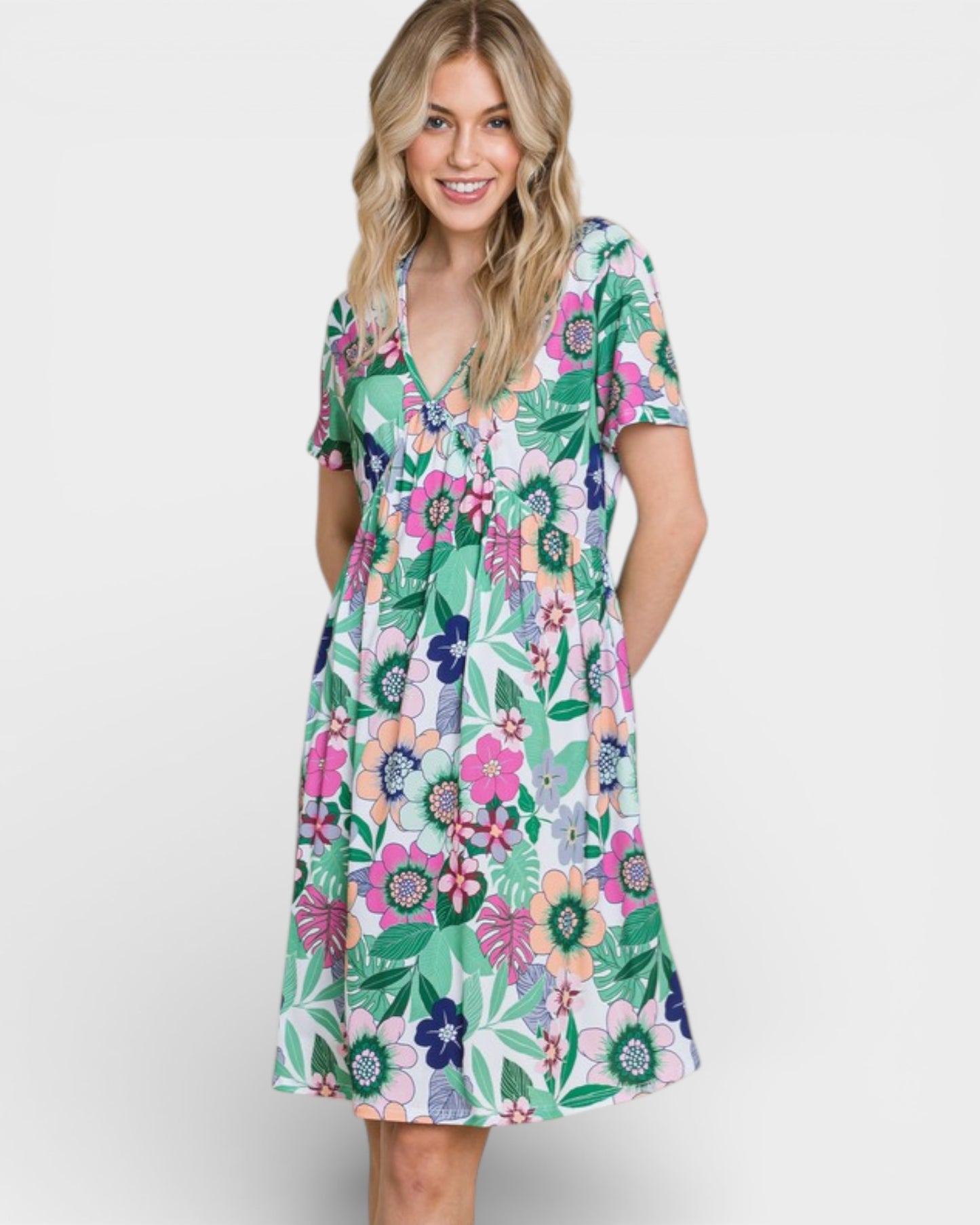 Woman wearing a colorful floral dress on a white background
