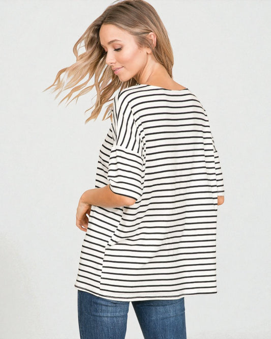 Woman wearing a black and white striped shirt on a plain background