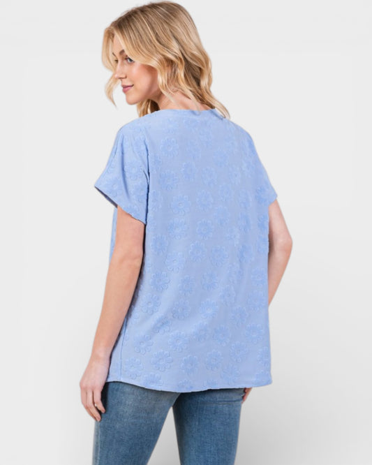 Woman wearing a light blue t-shirt and jeans on a white background