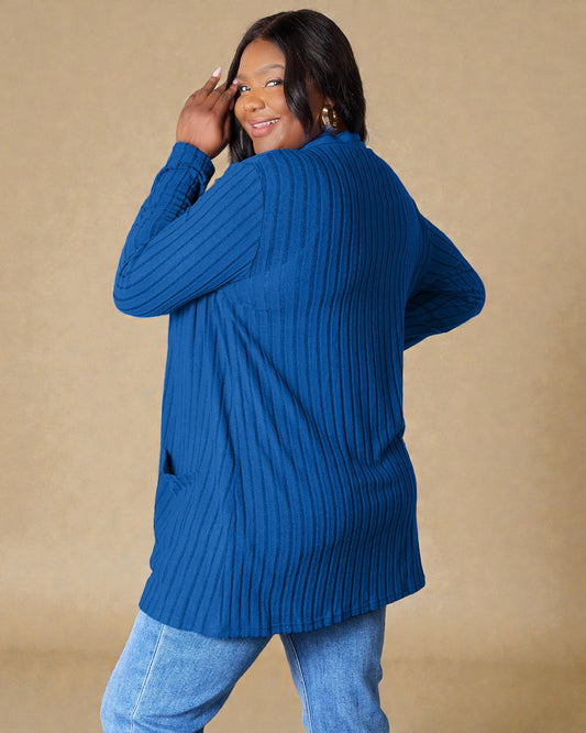 Woman wearing a blue ribbed sweater against a beige background