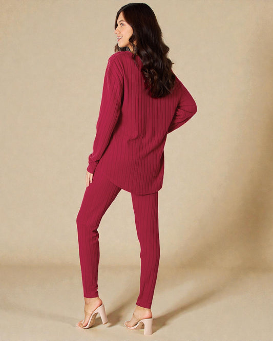 Woman wearing a maroon ribbed sweater and pants on a beige background