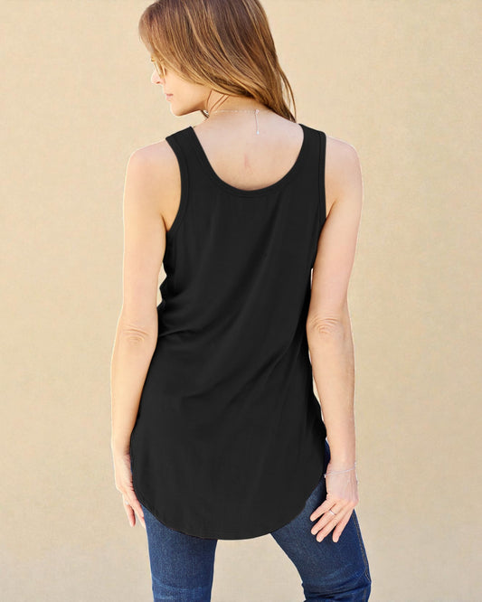 Woman wearing a black sleeveless top with a beige background