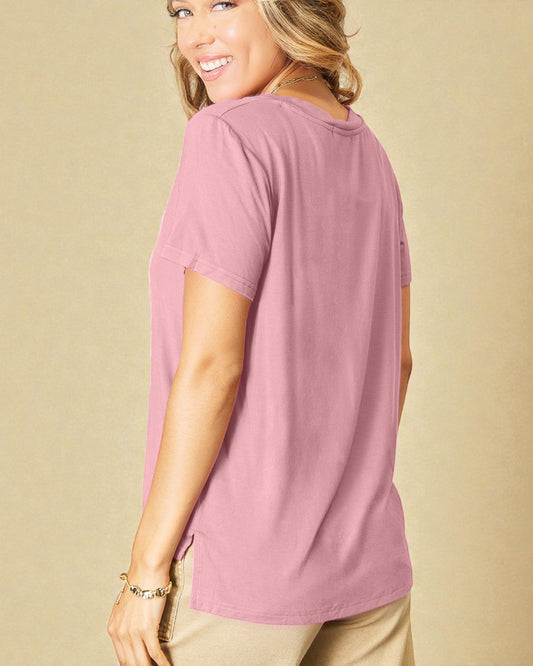 Woman wearing a pink t-shirt against a beige background