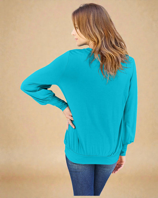 Woman wearing a turquoise sweater against a beige background