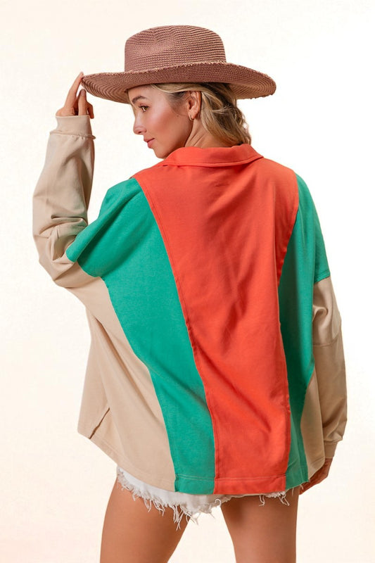 Woman wearing a colorful jacket with a neutral background