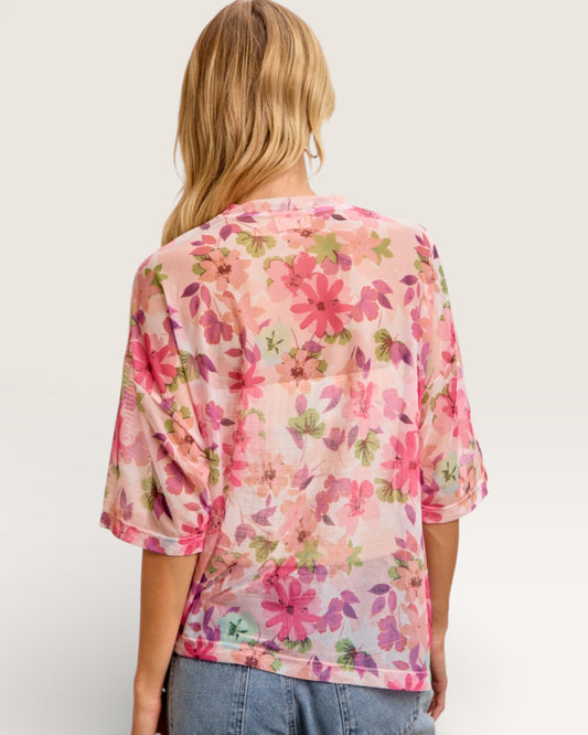 Woman wearing a floral blouse with a plain background