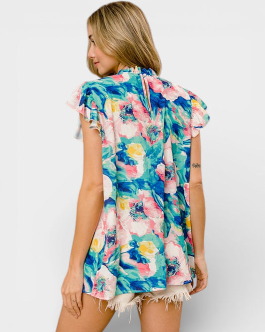 Woman wearing a colorful floral dress on a white background