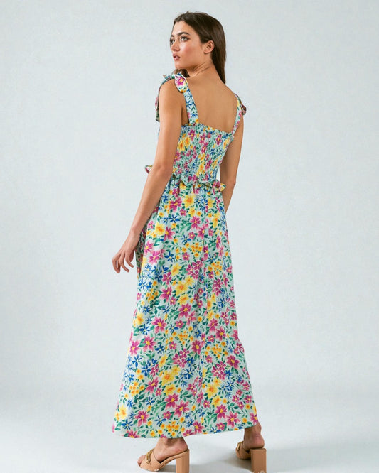 Woman wearing a colorful floral dress on a white background