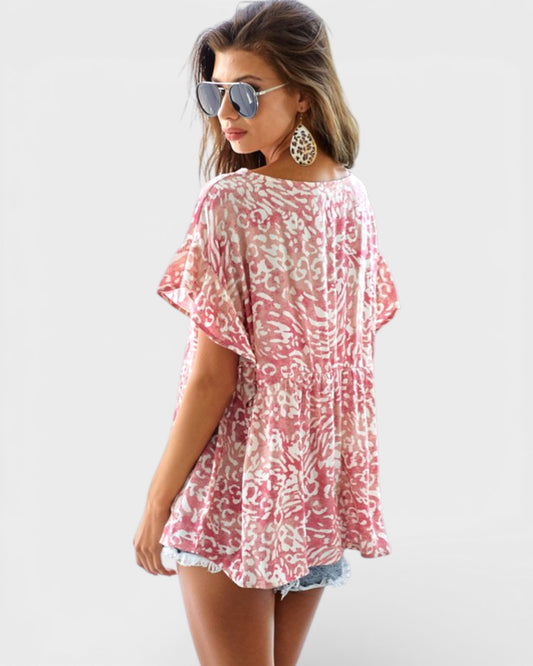 Woman wearing a pink floral cover-up on a white background