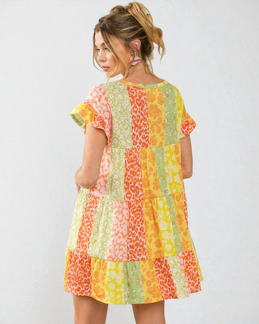 Woman wearing a colorful patchwork dress on a white background