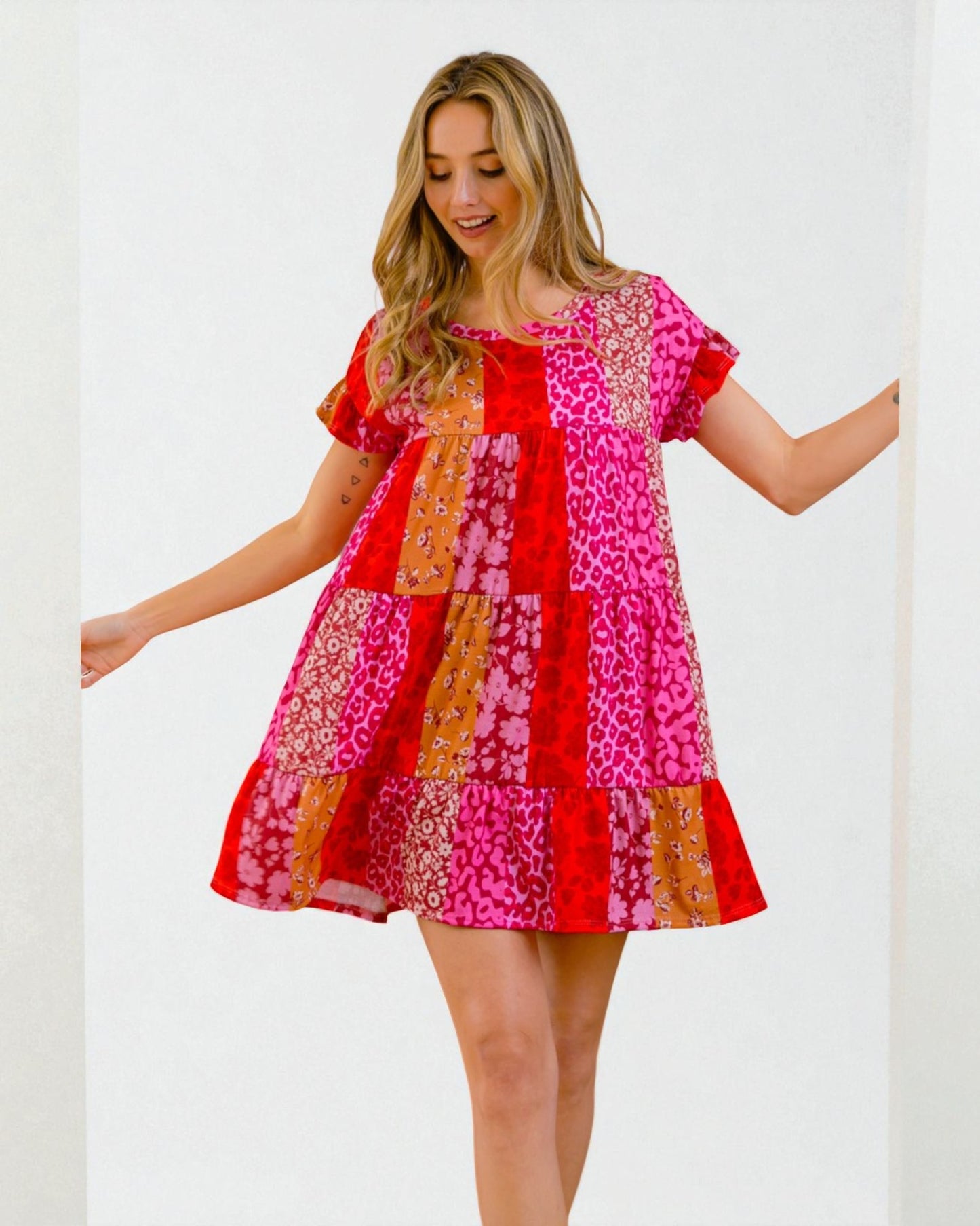Woman wearing a colorful patchwork dress on a white background