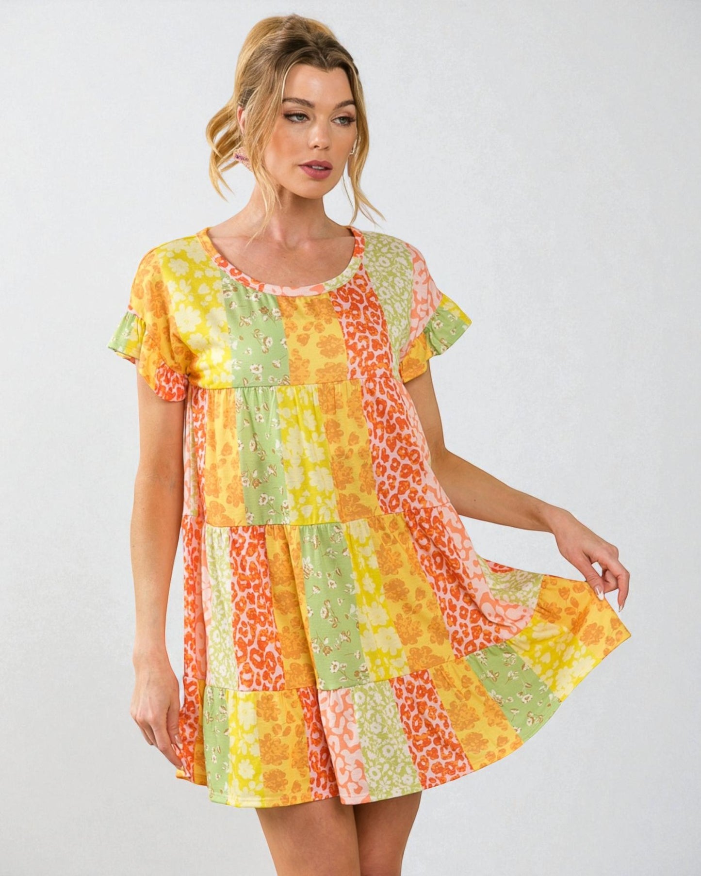 Woman wearing a colorful patchwork dress on a white background