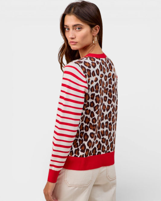 Woman wearing a sweater with red and white stripes and leopard print on a white background