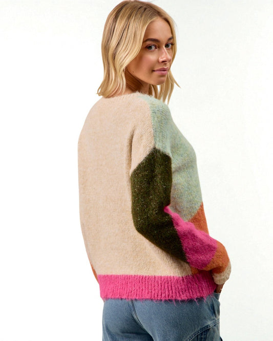 Woman wearing a colorful sweater with a white background