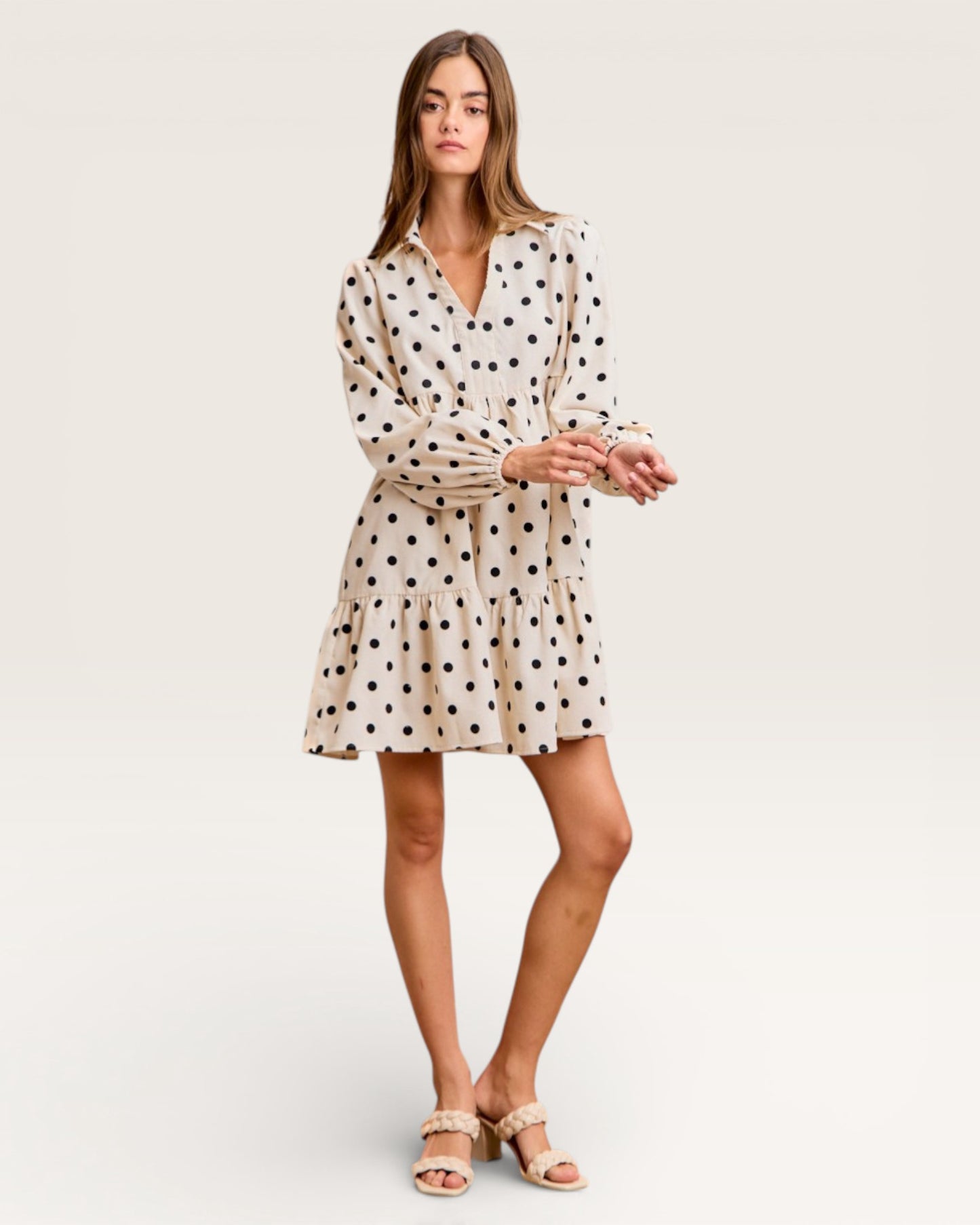 Woman wearing a polka dot dress on a white background