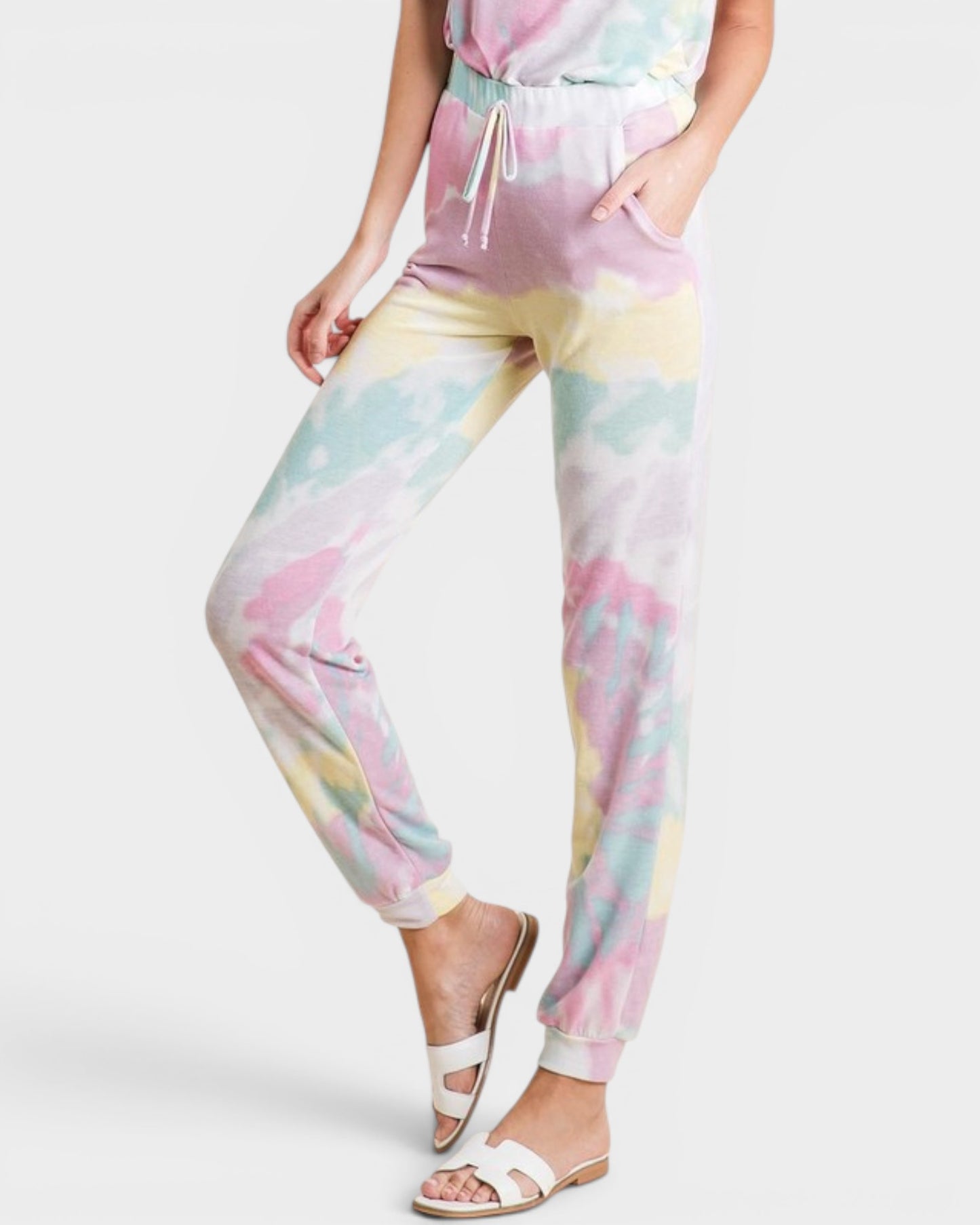 Person wearing a pastel tie-dye outfit on a white background