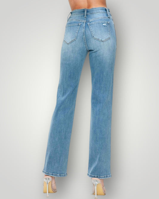 Light blue jeans worn by a person on a plain background