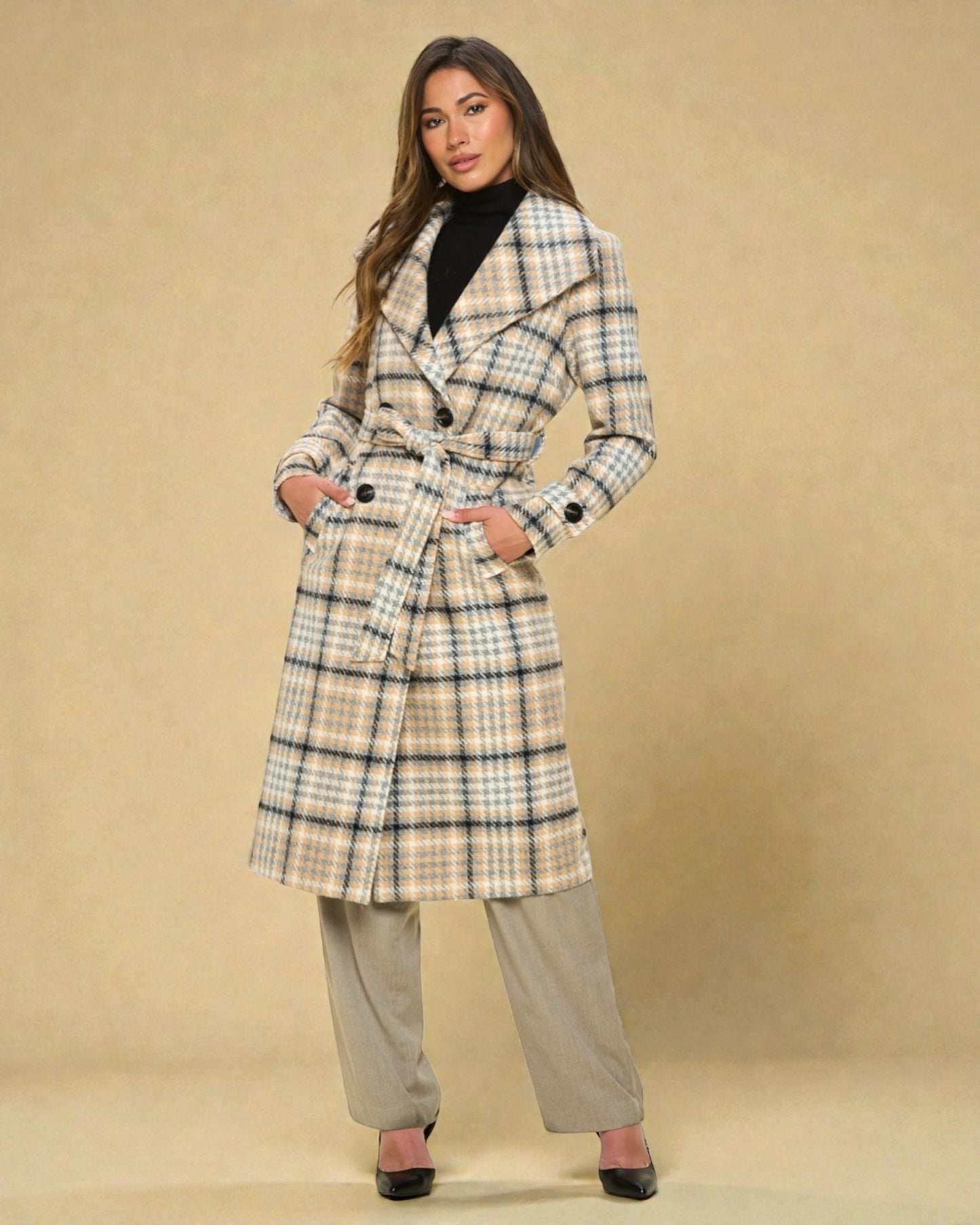 Woman wearing a plaid coat on a beige background