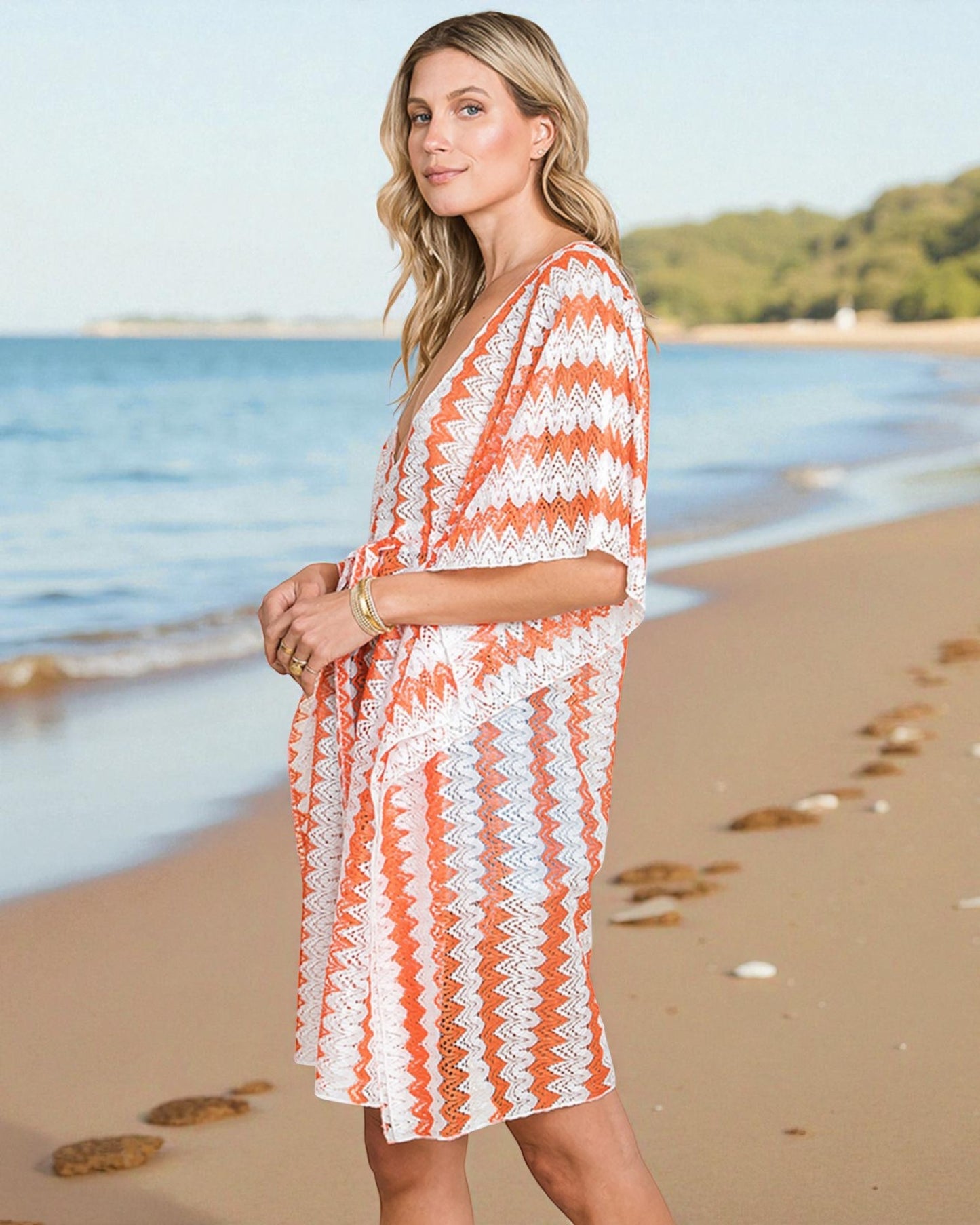 Woman in a striped orange and white cover-up on a beach