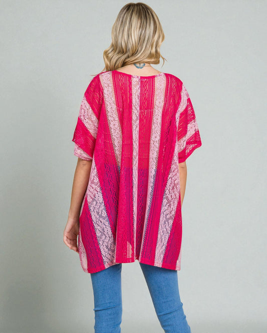 Woman wearing a pink and white striped kimono against a gray background