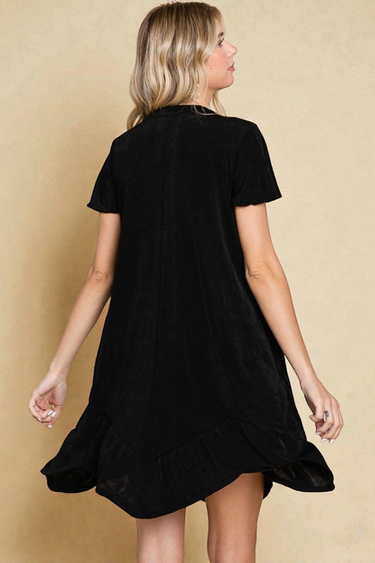 Woman wearing a black dress against a beige background