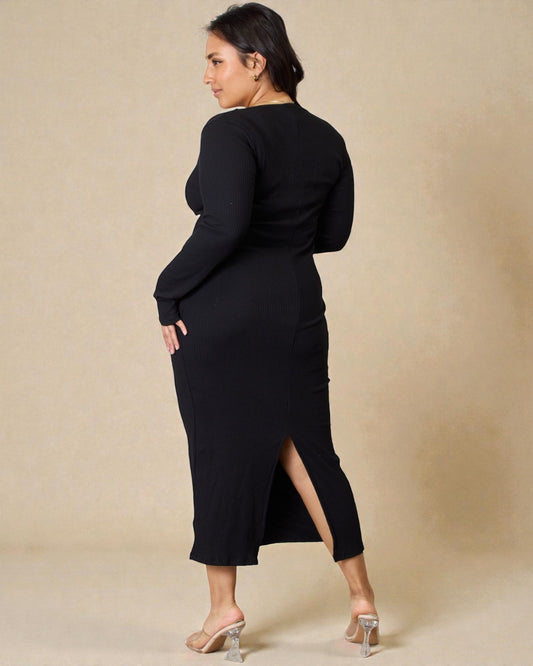 Woman wearing a black dress with a slit on a beige background