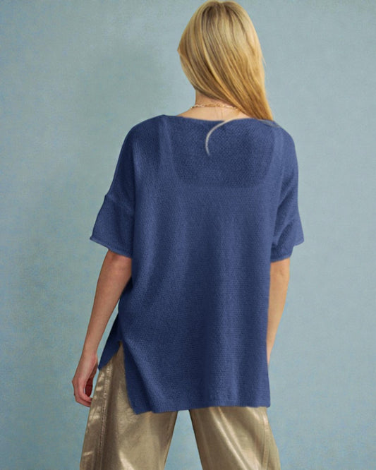 Person wearing a blue sweater with a plain background