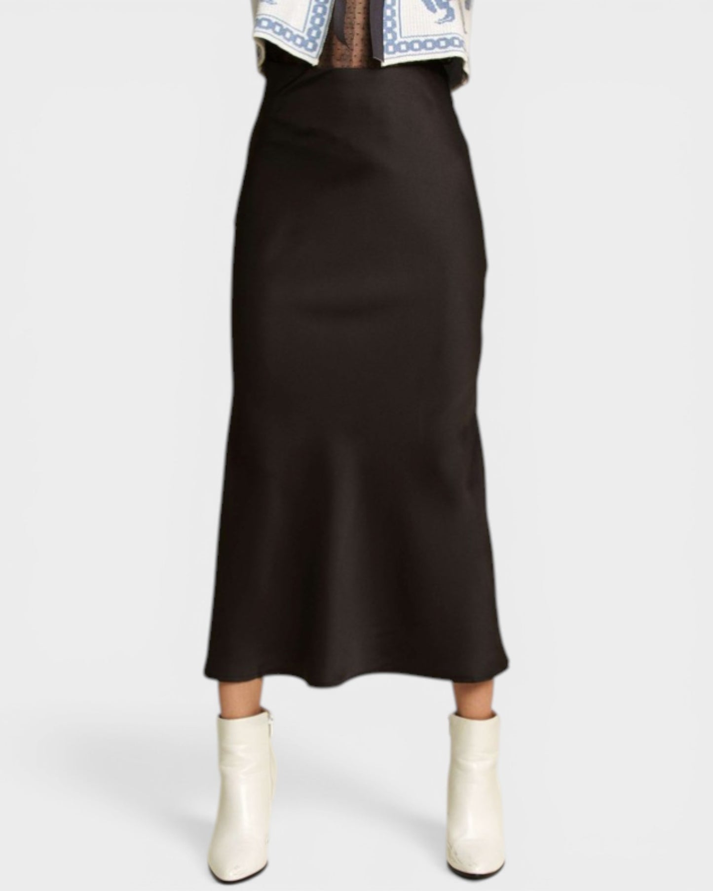 Black skirt worn by a person on a white background