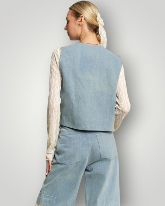 Person wearing a light blue vest and pants set on a plain background