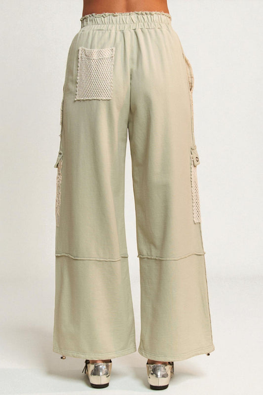 Beige wide-leg pants with pocket details on a white background