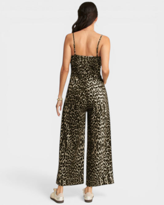 Woman wearing a leopard print jumpsuit on a white background