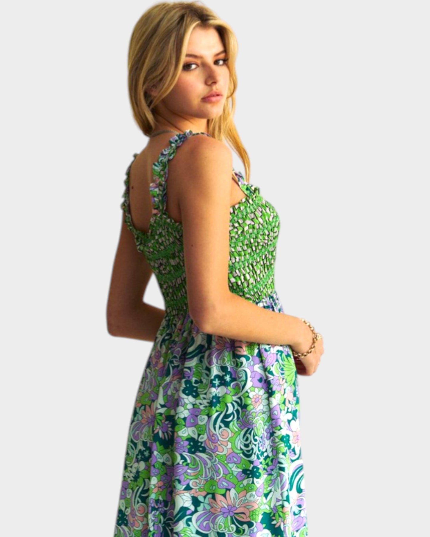 Woman wearing a green floral dress on a white background