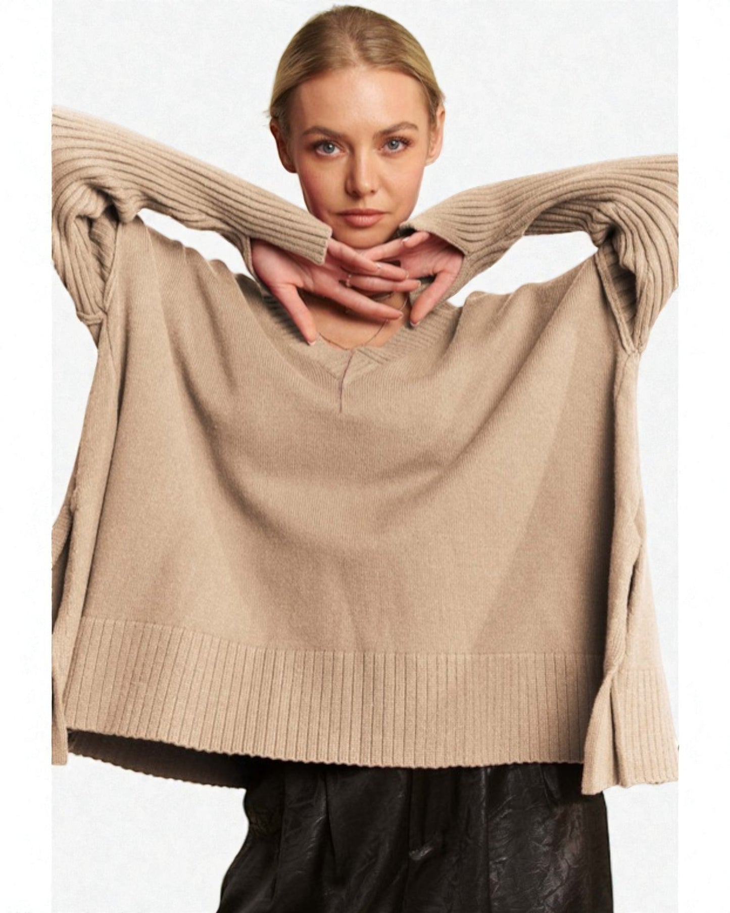 Woman wearing a beige sweater with a plain background