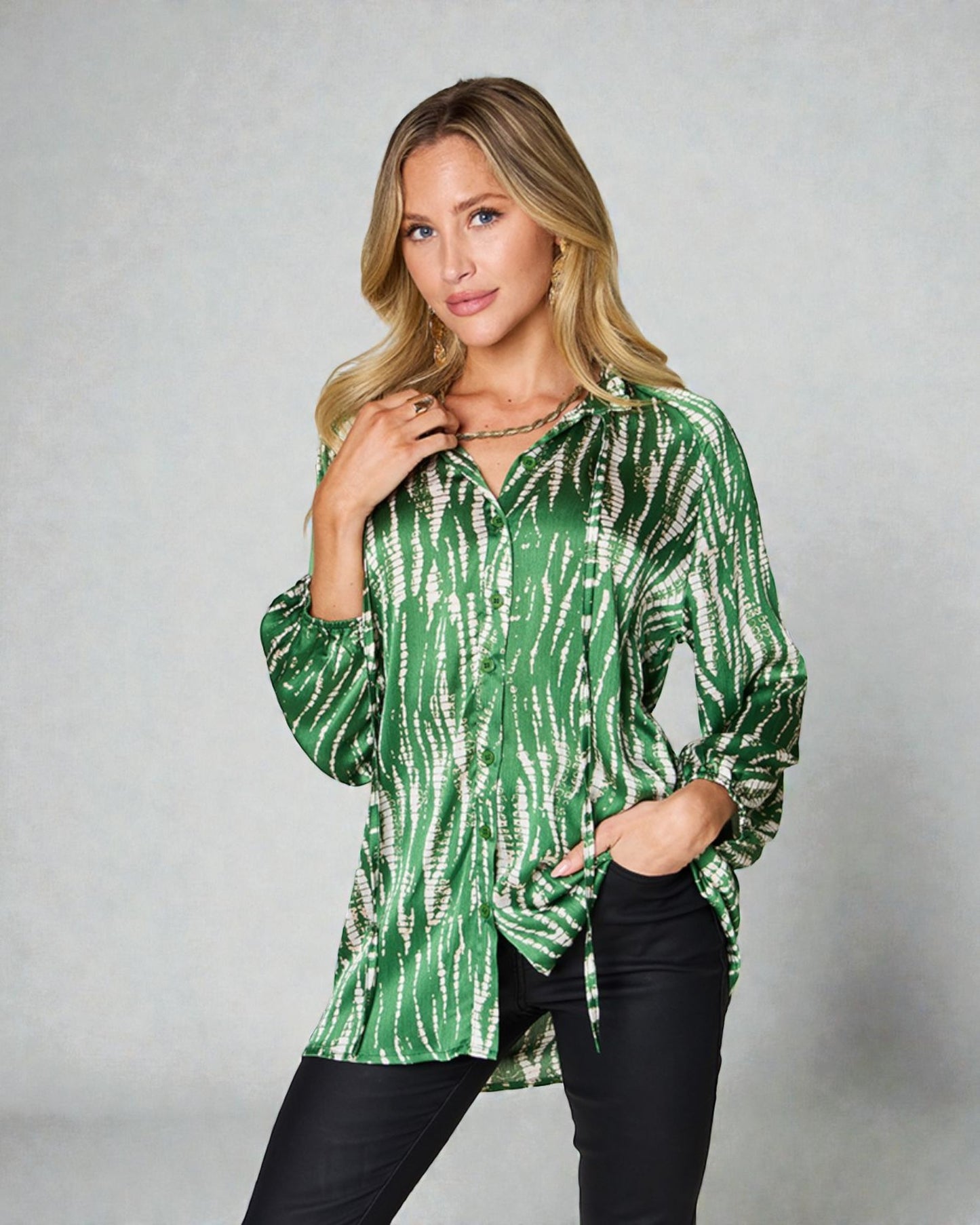 Woman wearing a green tie-dye shirt against a gray background