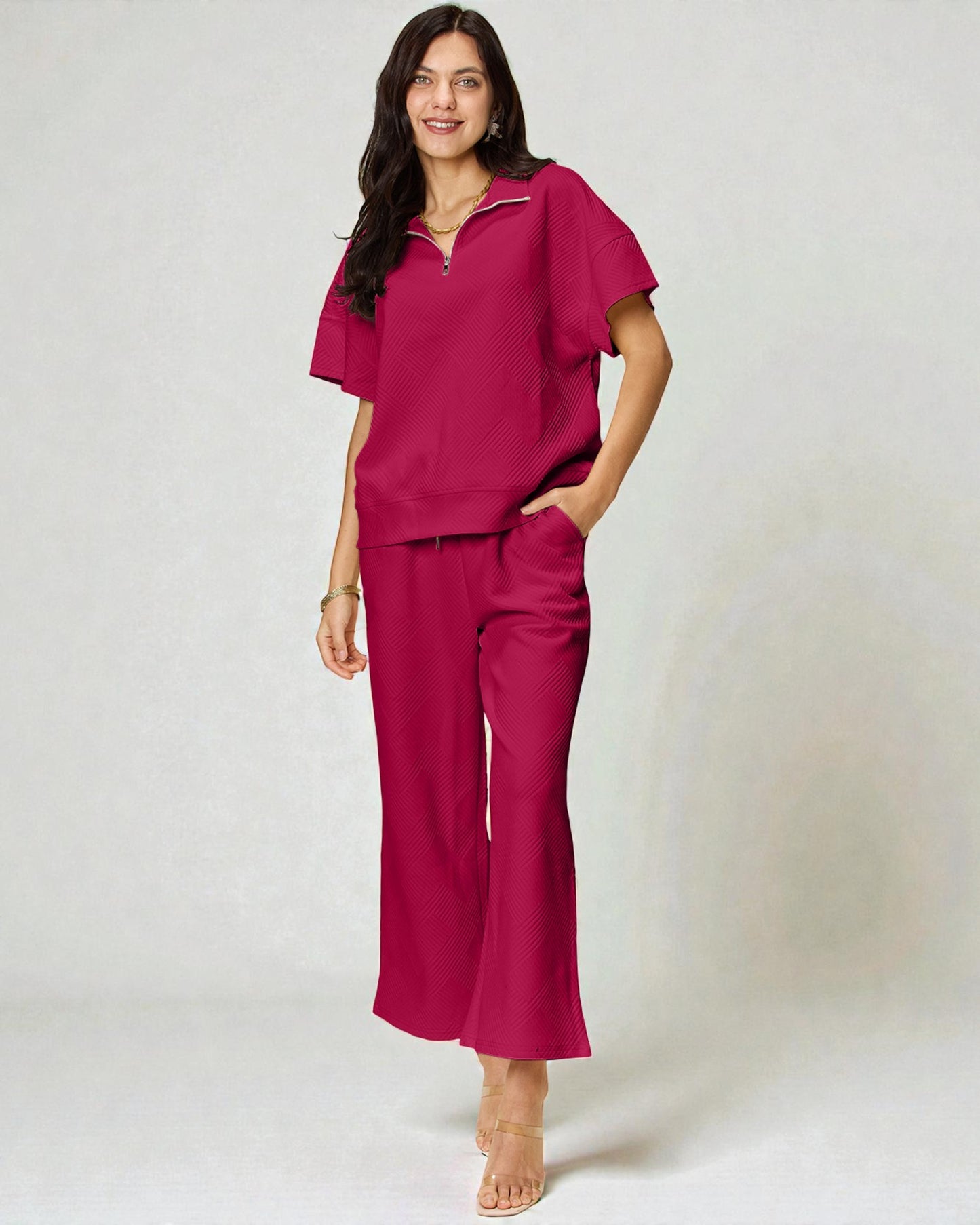 Woman wearing a magenta outfit on a white background