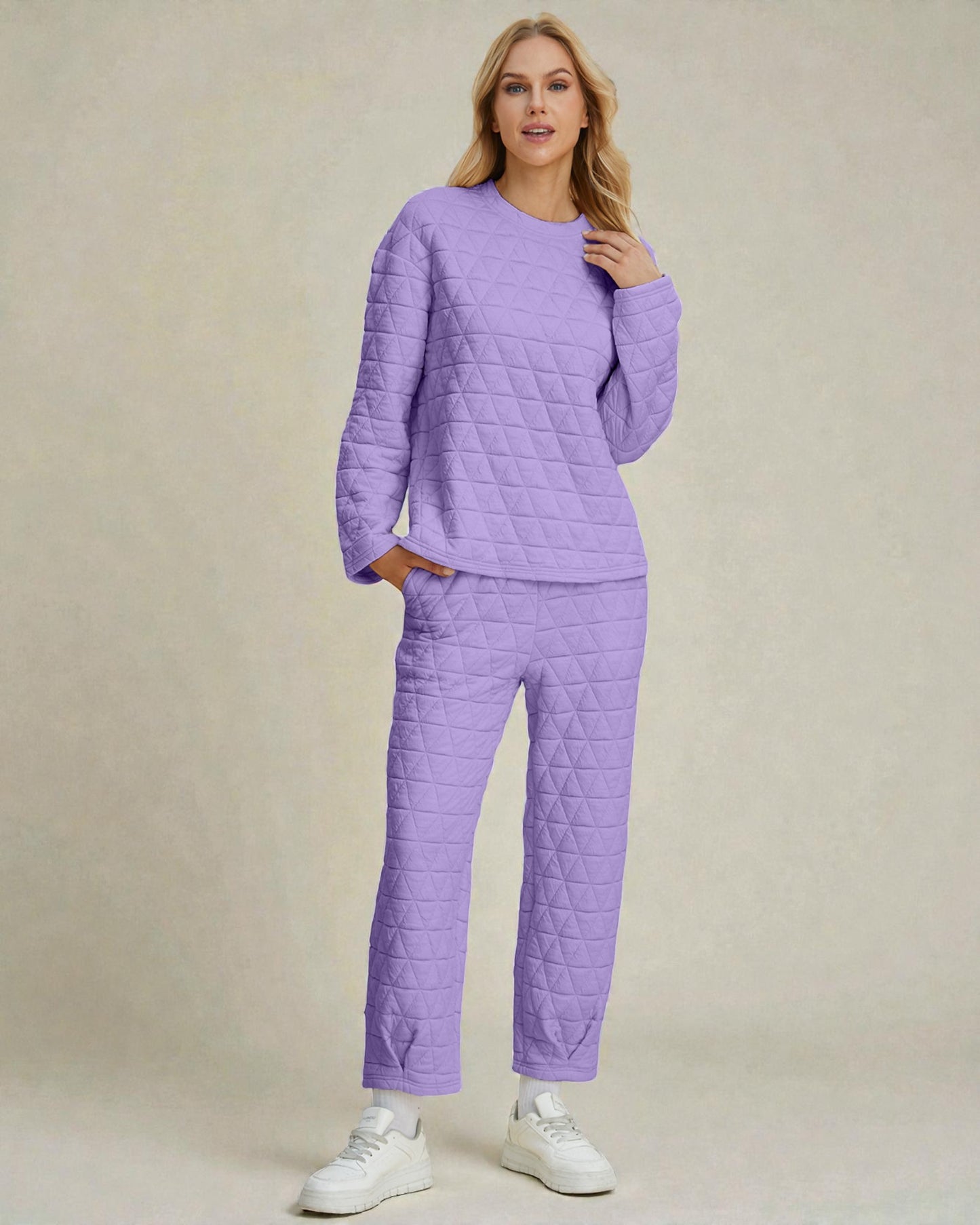 Woman wearing a purple quilted outfit on a beige background