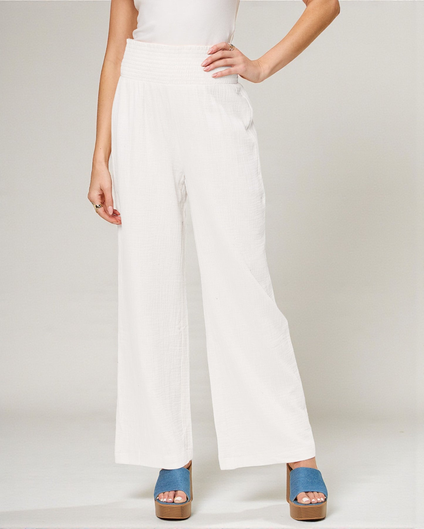 White wide-leg pants worn by a person on a plain background