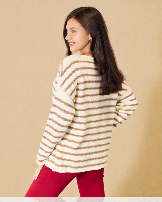 Woman wearing a striped sweater and red pants against a beige background