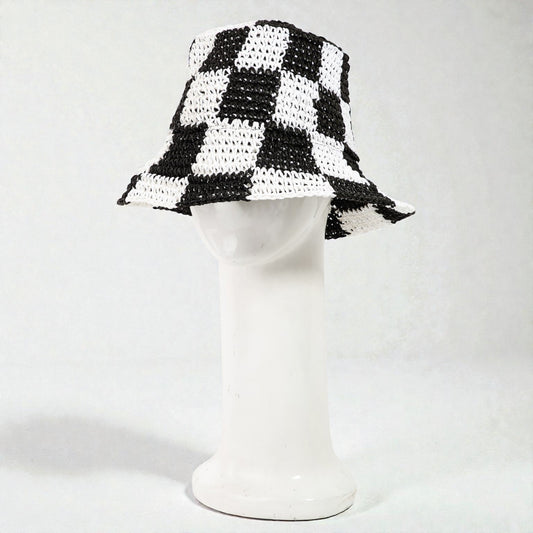 Black and white checkered bucket hat on a mannequin head against a white background