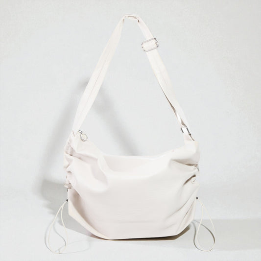 White shoulder bag on a light gray background