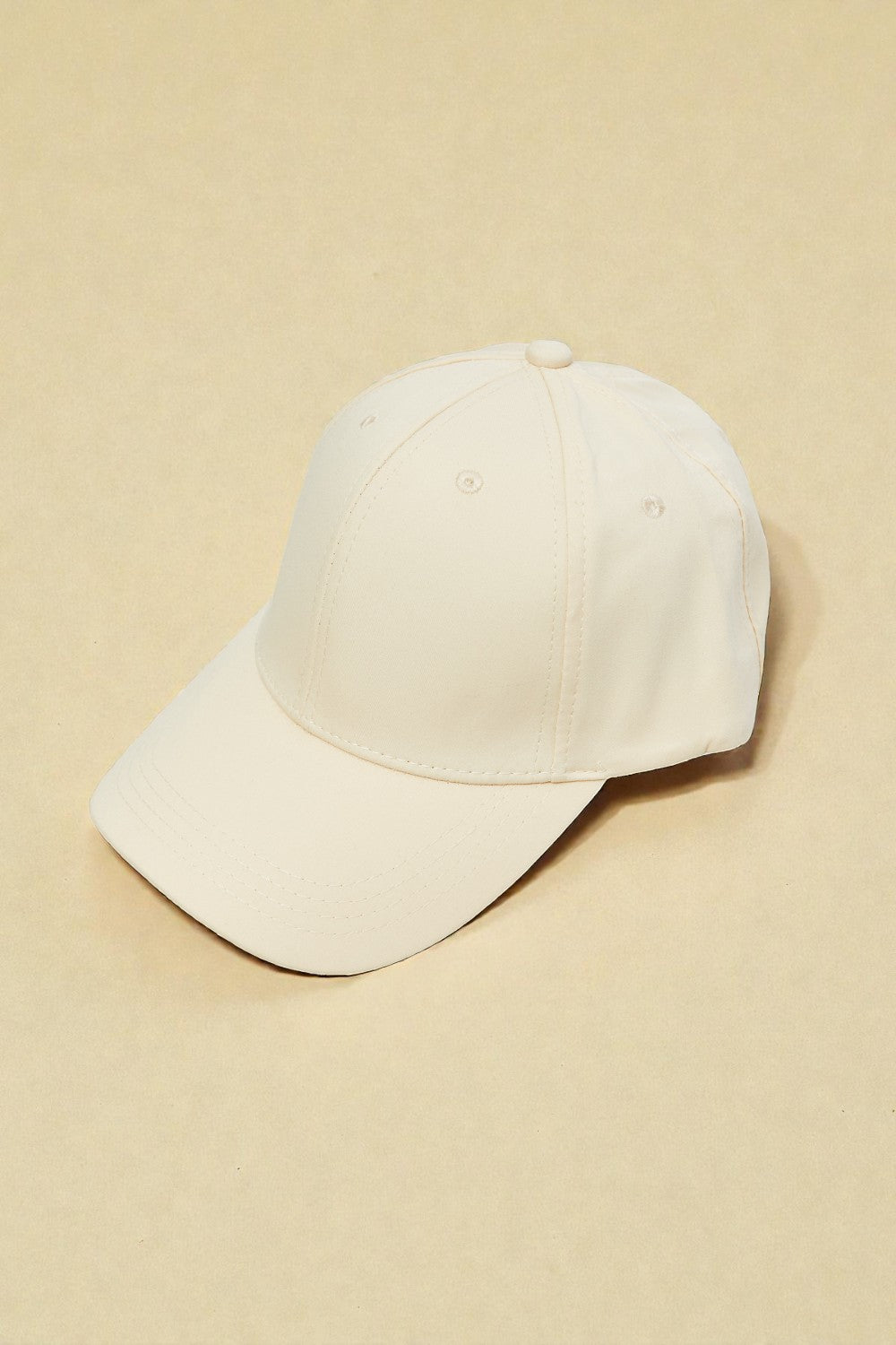 Beige baseball cap on a beige background