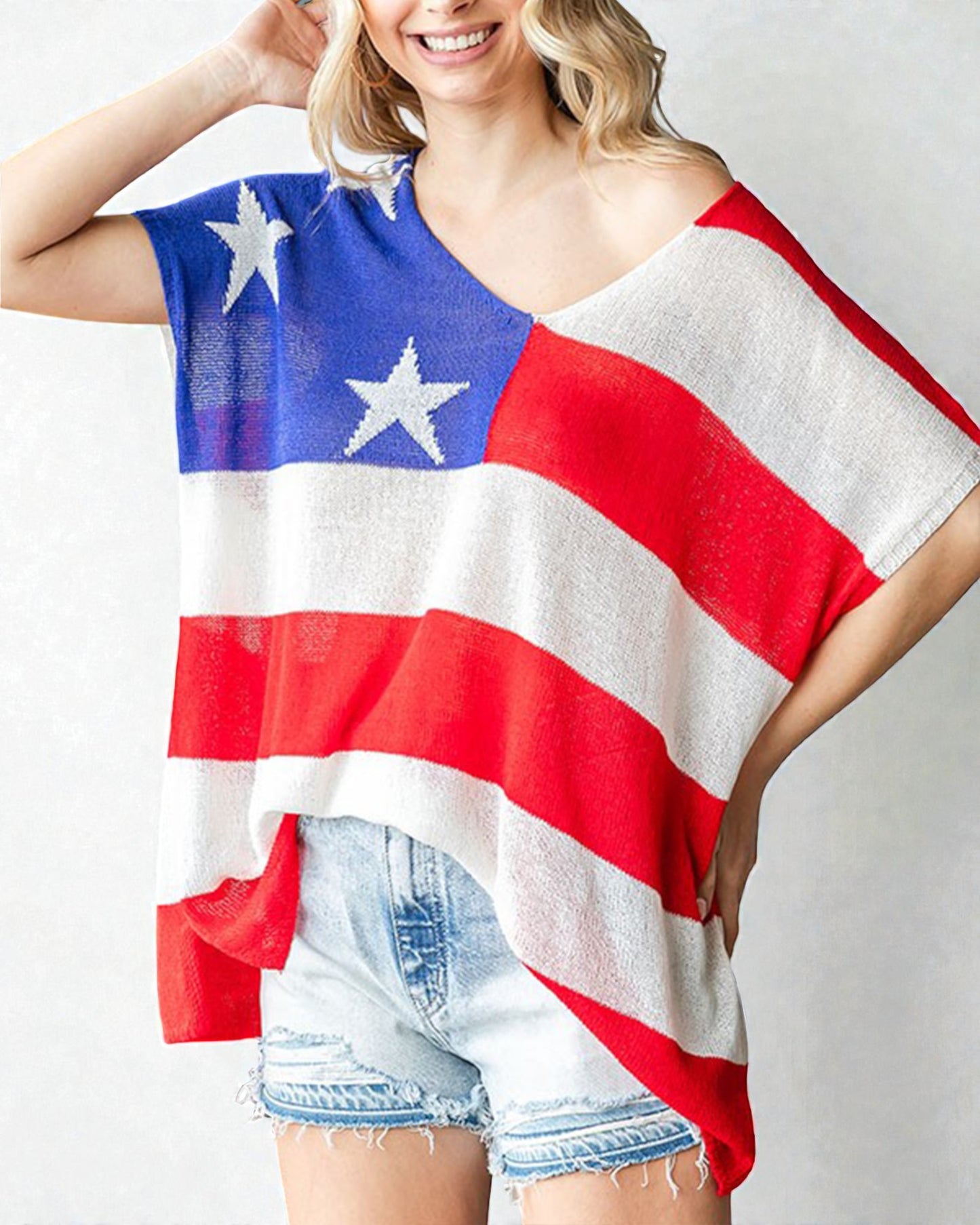 Person wearing a red, white, and blue flag-themed top with stars on a plain background