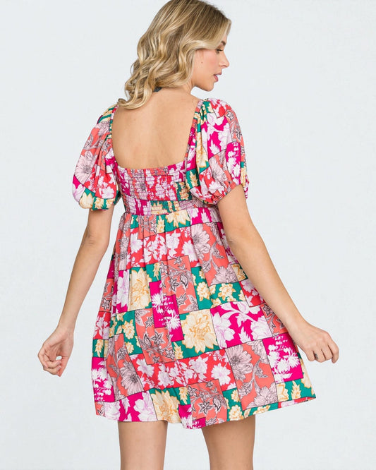 Woman wearing a colorful patchwork dress on a white background