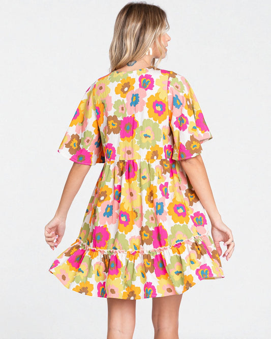 Woman wearing a colorful floral dress on a white background